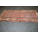 Red ground rug having blue,