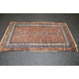 Rust ground rug having blue, green and white pattern - 76" x 44.