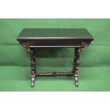 Ebonised and gilt painted fold over card table the top opening to reveal baize playing surface