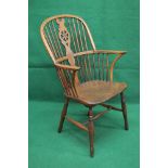 Yew wood and elm wheel back Windsor chair having solid seat supported on turned stretchered legs