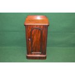 Victorian mahogany pot cupboard the top having moulded edge with raised back over single arched