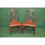 Set of four Georgian mahogany dining chairs having pierced and carved back splats,