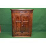19th century mahogany cross banded corner cupboard having two panelled doors opening to reveal