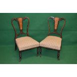 Pair of mahogany nursing chairs the backs having decorative inlaid panels supported by sweeping