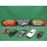 Seven 1:18 scale boxed and loose diecast Jaguar and Aston Martin model cars by various