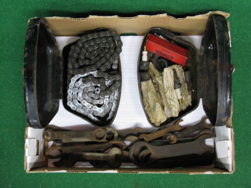 Two motorcycle tool boxes containing chains and spark plugs together with spanners embossed