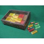 Counter top display case containing approx forty five Lodge Spark Plugs in yellow, red, maroon,