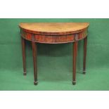 Mahogany demi lune card table having cross banded top opening to reveal green baize playing surface,