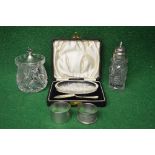 Group of silver items to comprise: two napkin rings, silver topped pepper shaker,