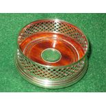 Silver and mahogany wine bottle coaster having raised pierced sides,