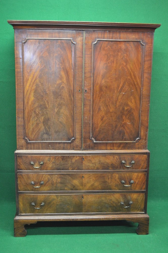 Mahogany linen press having moulded cornice over two panelled doors opening to reveal hanging space