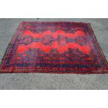 Red ground rug having blue,