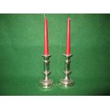 Pair of silver plated candle sticks the sconces having raised decoration of fruit and flowers,