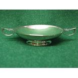 Silver two handled dish standing on a circular footed base,