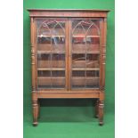 Mahogany glazed bookcase having moulded cornice over reeded columns and two glazed doors opening to