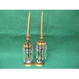 Pair of 19th century bronze and gilt metal figural candle sticks having facet cut glass drops,