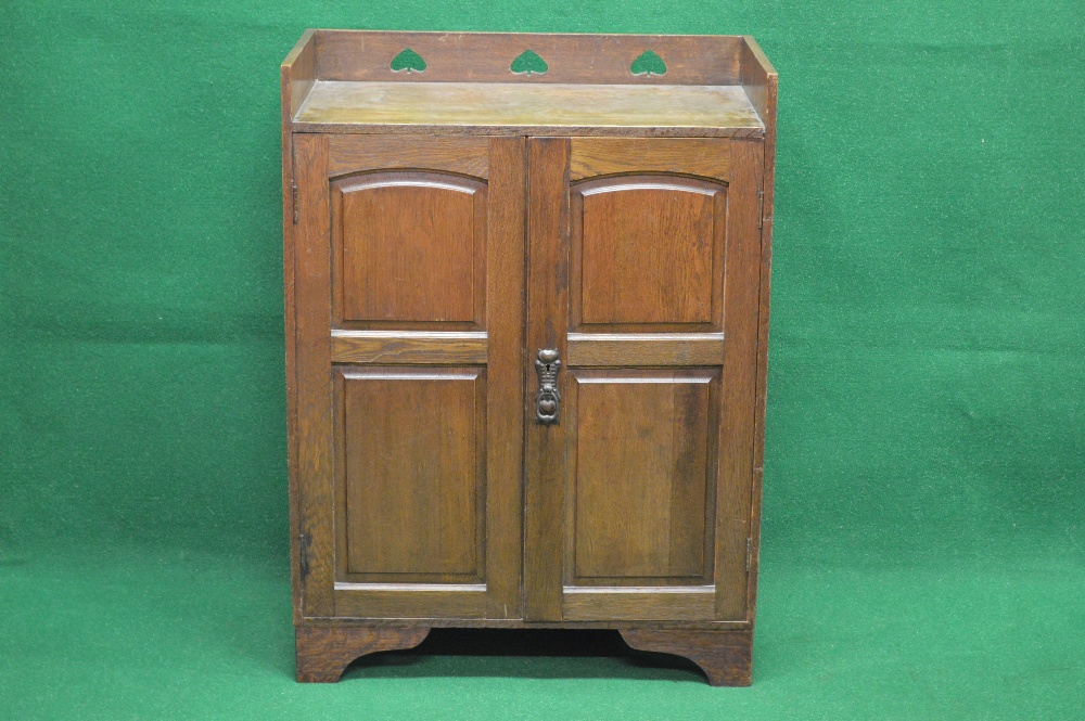 Circa 1900 Arts & Crafts oak cupboard with spade cut out raised gallery over two panelled doors