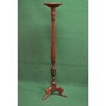 Mahogany torchere having circular top supported on a reeded and carved column leading to three