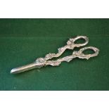 Pair of silver grape scissors with embossed vine decoration,