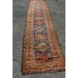 Blue ground carpet runner having red,