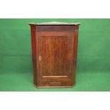 Georgian oak wall hanging corner cabinet having moulded cornice over single panelled door opening