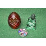 Group of three pieces of glassware to comprise: red glass paperweight of oval form having cut
