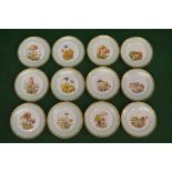 Set of twelve Royal Copenhagen cabinet plates having gilt borders on a soft green ground