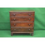 Mahogany chest of four long graduated drawers with turned knob handles and brass escutcheons,