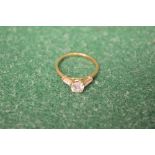 14ct gold ladies ring set with single central stone flanked by single stone to either shoulder