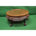 Hardwood circular Oriental style coffee table having carved frieze decorated with fruits and