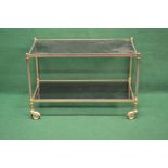 Brass and glass two tier trolley the top having smoked glass supported on reeded brass uprights