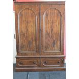 Victorian mahogany double wardrobe having moulded cornice over two arched panelled doors opening to