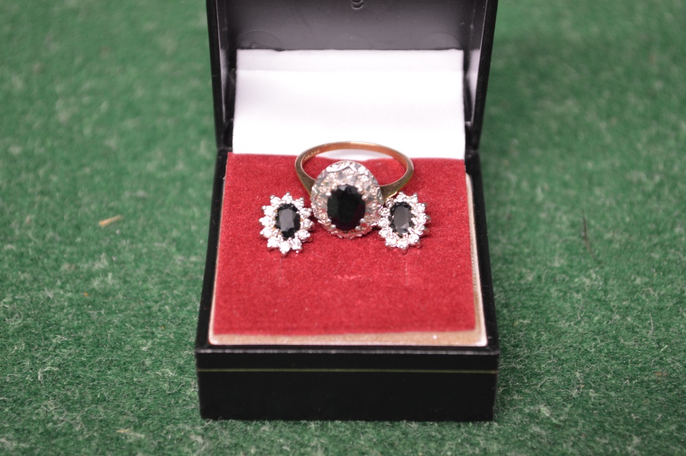 9ct gold ladies ring set with central black stone surrounded by small diamond chips together with