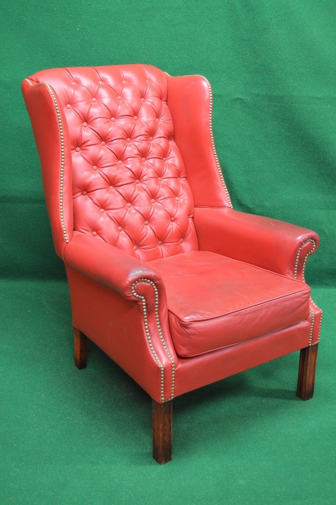 Late 20th century Georgian style red leather wing back armchair having buttoned back and studded