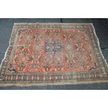 Red ground rug having blue, pink and green pattern - 82" x 63.