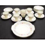 Susie Cooper part tea set having floral pattern with pale blue border to comprise: six tea cups,