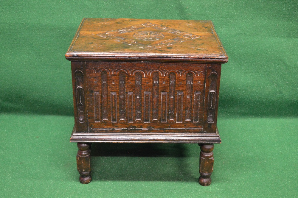 19th century oak chest the top having carved decoration lifting to reveal storage space,