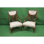 Pair of mahogany open armchairs having carved top rails over embroidered padded backs and pierced