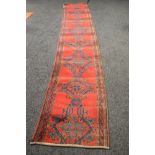 Red ground carpet runner having blue, green and gold decoration - 171" x 27.