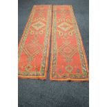 Pair of red ground carpet runners having green, orange and yellow decoration - 141" x 35.