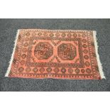 Red ground rug having black pattern with end tassels - 46" x 32"