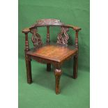 19th century oak carved corner chair the top rail carved with flower heads and leaves supported by