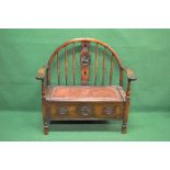 20th century oak settle having arched back with turned spindles and pierced back splat,