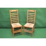 Pair of Arts & Crafts rush seated ladder back chairs with pewter and ebony chequer inlay in the