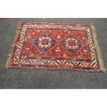 Red ground rug having orange,