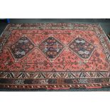 Red ground rug having white, black,