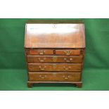 Georgian oak cross banded bureau having two short over three long graduated drawers with brass