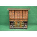 Oriental apothecary table top cabinet having forty two drawers with hoop handles and carved