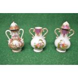 Two Augustus Rex miniature two handled lidded urns (one lid missing) decorated with panels of