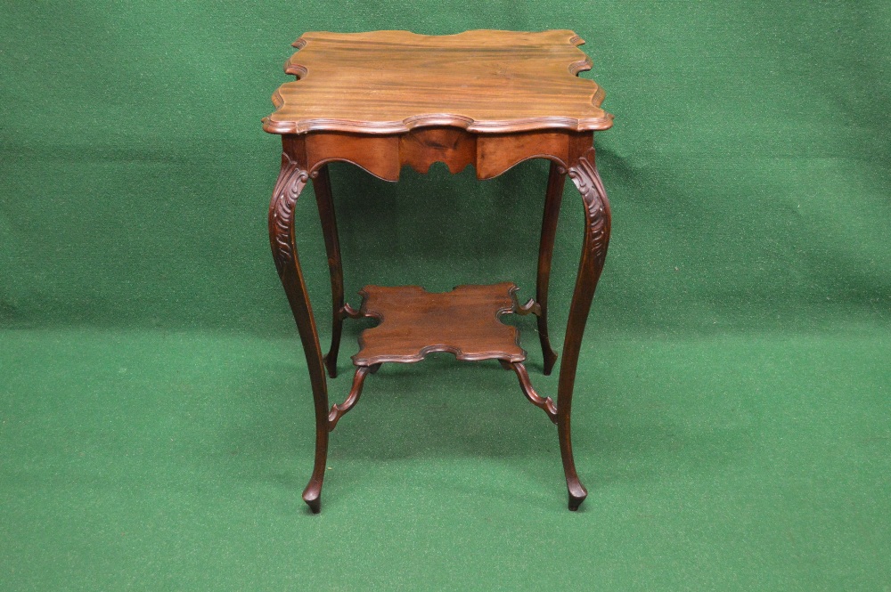 Square mahogany two tier occasional table the top having shaped edges supported on carved cabriole